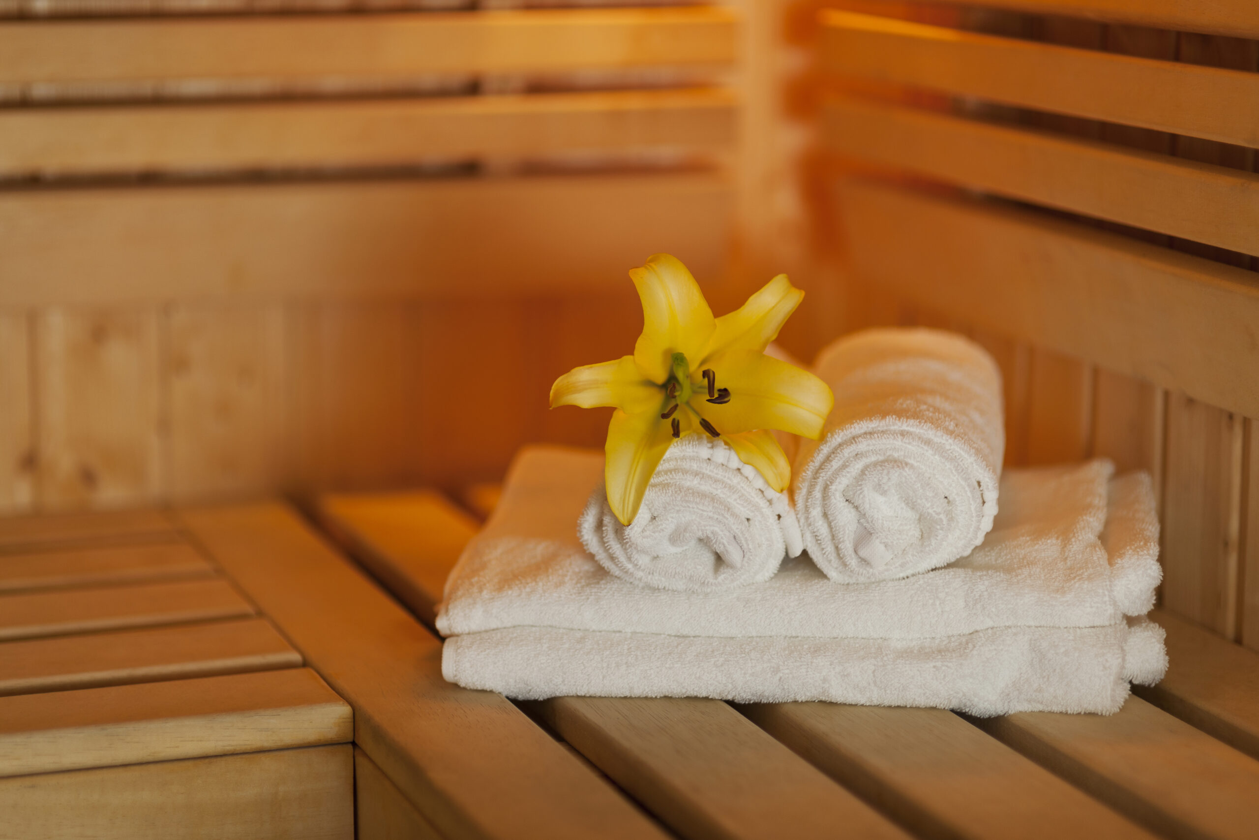 fresh towels and yellow lily in sauna