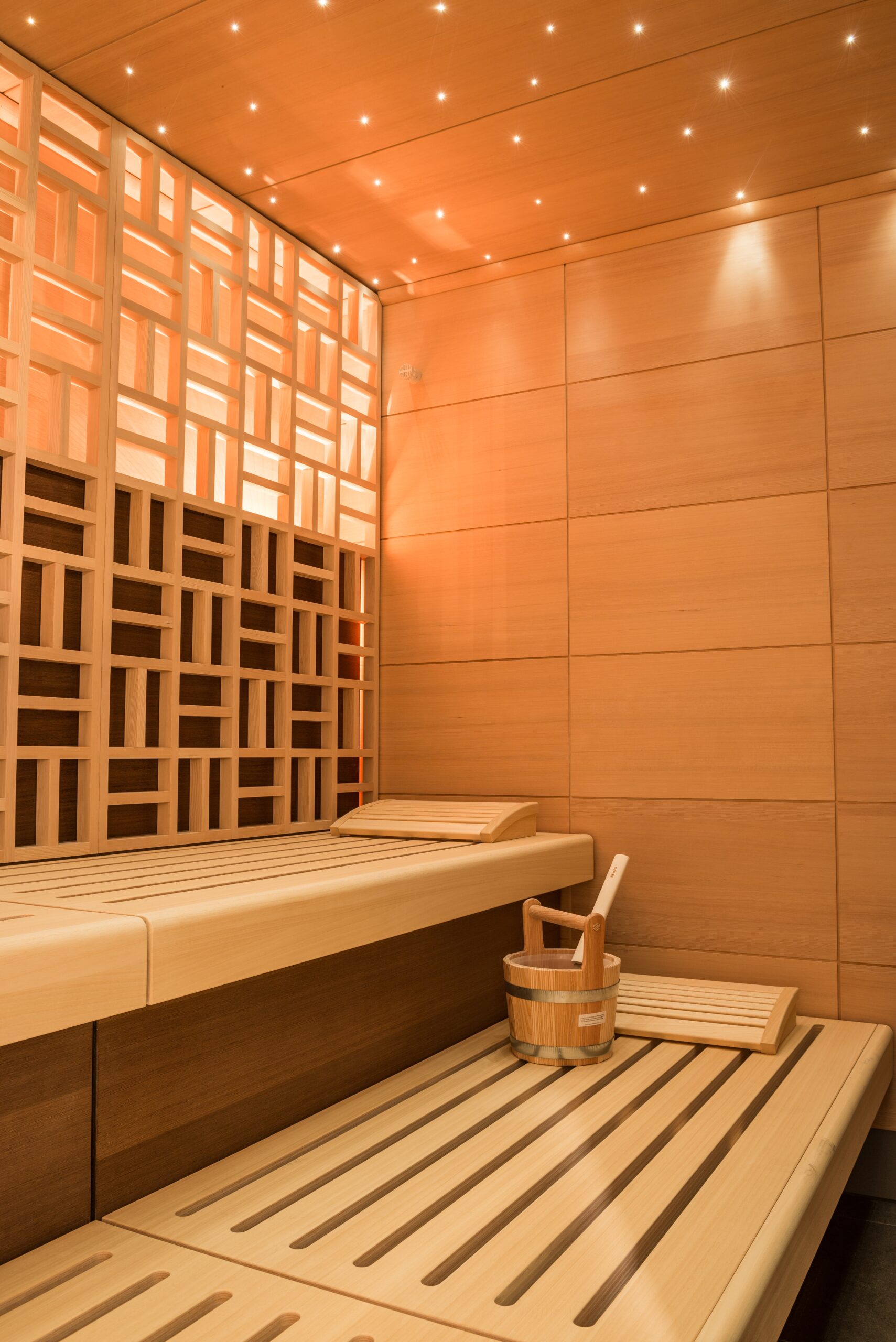 vertical shot beautiful sauna room design with wall tiles wooden bench